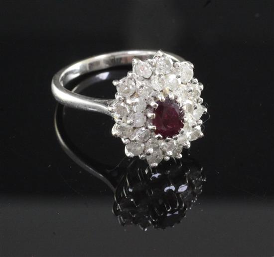 A 18ct white gold ruby and diamond oval cluster ring, size O.